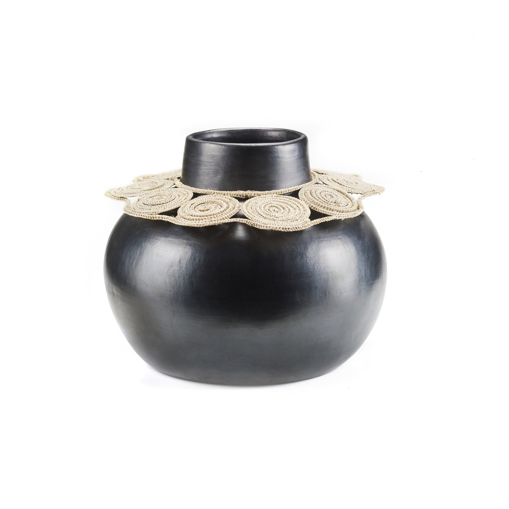 The Ames Coyar Vase 1 by Ames is a round, black ceramic vase with a wide neck and beige wickerwork coiled around the opening, displayed on a white background.