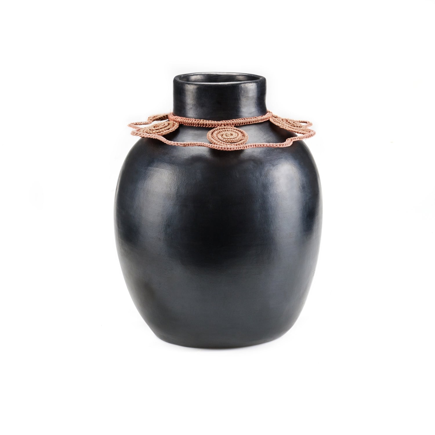 The Ames Coyar Vase 2 is a smooth, black ceramic piece featuring a wide body, narrow neck, and intricate pink rosette design around the top. Its elegant charm stands out against a simple white background.