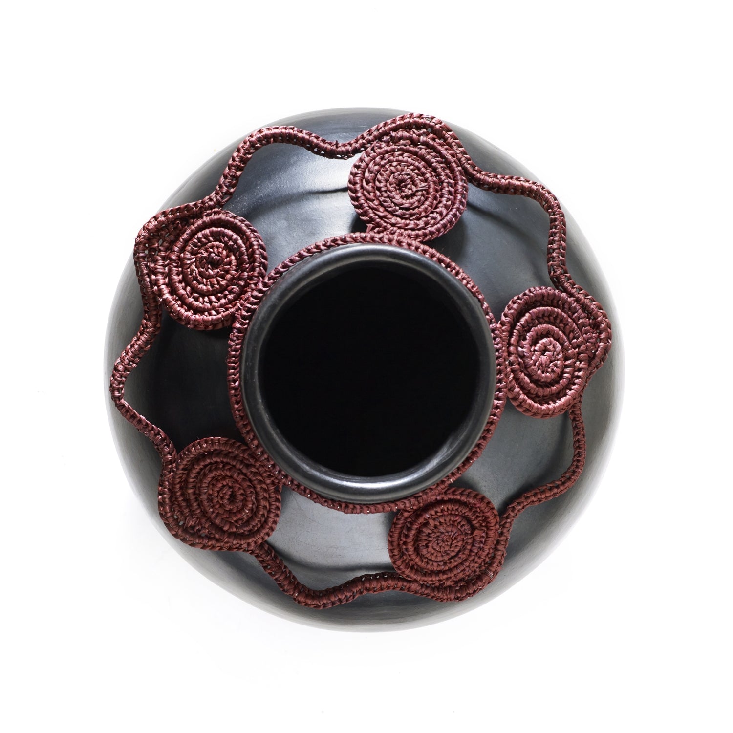 Top view of the Coyar Vase 2 by Ames, featuring a wide opening and red rope-like designs reminiscent of wickerwork. The intricate detailing contrasts beautifully with its smooth, dark finish.