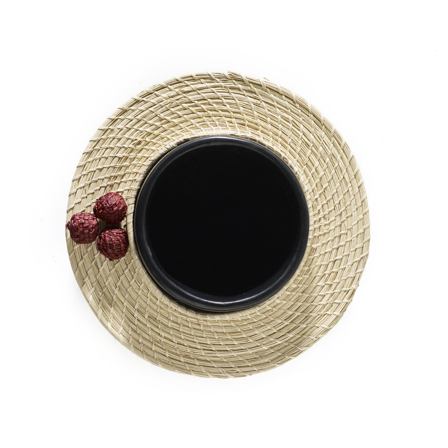 The Ames Coyar Vase 3 by Ames sits on a round wickerwork decoration, with three red lychees to the left. The background is white.