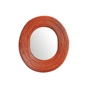 The Ames Killa Mirror by Ames features a thick, textured frame handcrafted from Iraca palm in a rich reddish-brown hue, beautifully set against a white background.