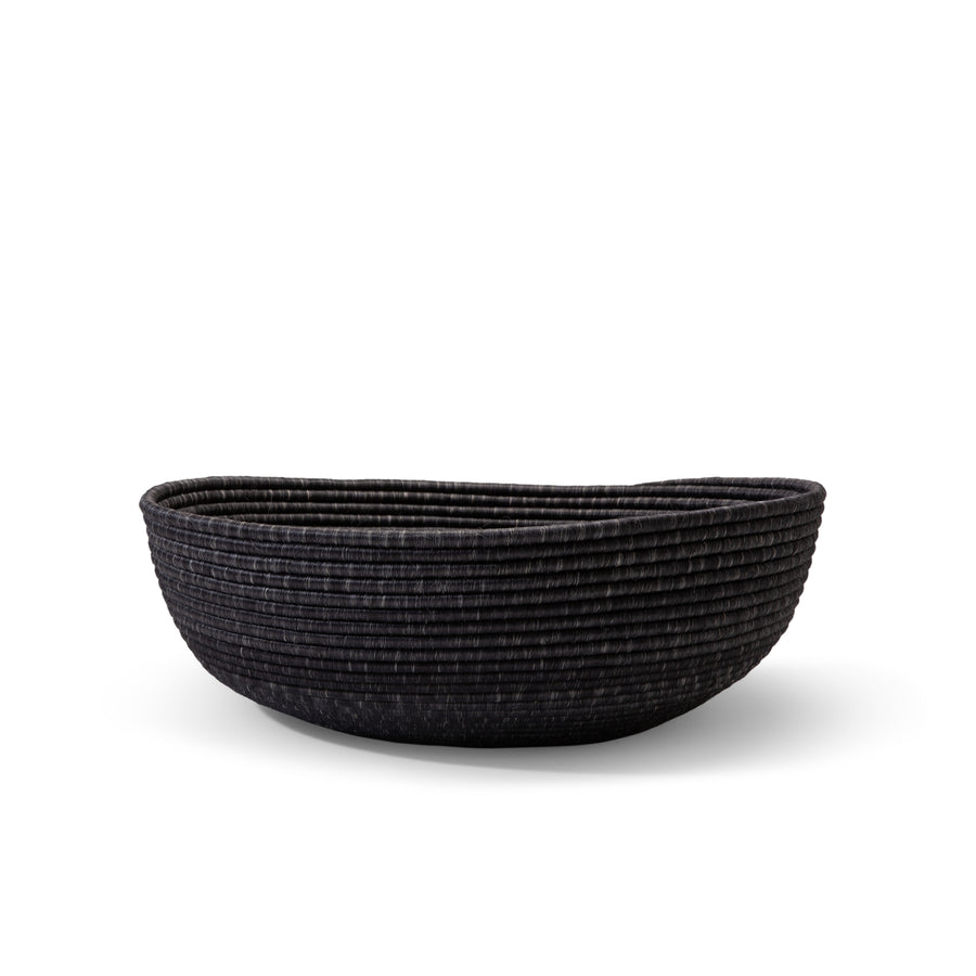The Ames La Che Basket by Ames is a wide, shallow black basket made of textured Fique fibers, shown against a white background.