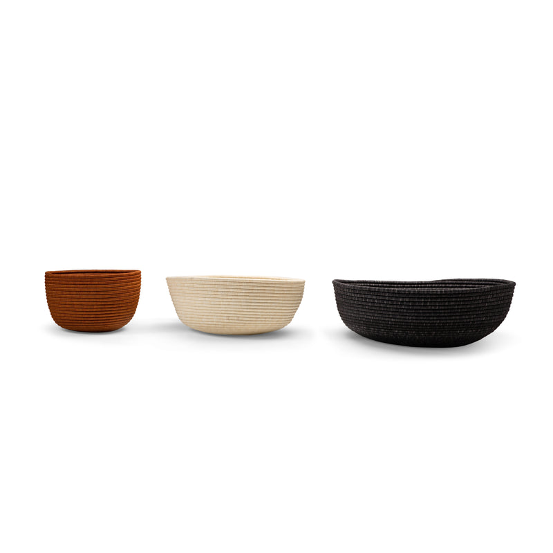 Three Ames La Che Baskets by Ames—small brown, medium white, and large black—are displayed in a row against a white background.