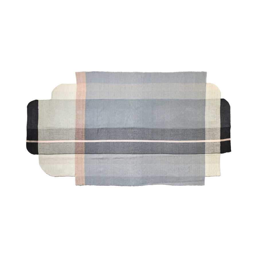 The Ames Muyska Rug by Ames is a rectangular, hand-woven wool rug in light blue, beige, gray, and black with horizontal and vertical stripes and rounded corners on two sides.