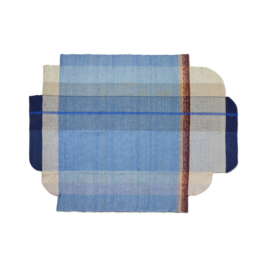 The Ames Muyska Rug by Ames is a hand-woven wool rug with overlapping rectangles, rounded shapes in blue, beige, cream, and a vertical brown stripe for a layered geometric abstract look perfect for modern interiors.