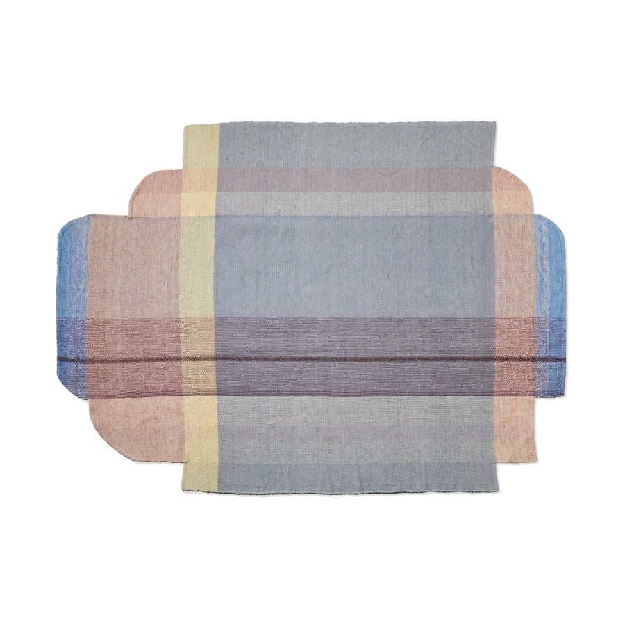 The Ames Muyska Rug by Ames is a contemporary hand-woven wool rug with softly rounded corners, showcasing overlapping bands of muted gray, pink, blue, yellow, and beige in a plaid-like abstract pattern on a white background.