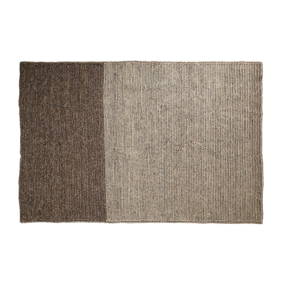 The Ames Par Rug by Ames features a rectangular handmade design split vertically: the left side displays rich dark brown tones, while the right is a lighter beige with a subtle striped texture.