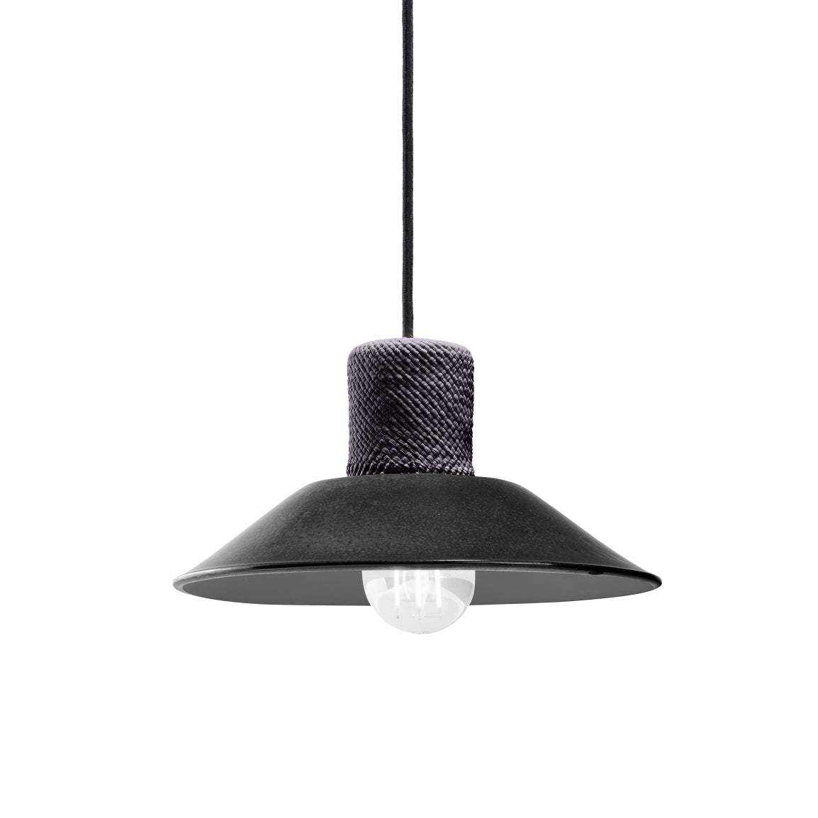 The Ames Raiz Pendant Lamp Small by Ames features a black, wide flat shade, visible bulb, and textured dark cylindrical cap, all handcrafted in Colombia. It hangs from a black cord against a white background.
