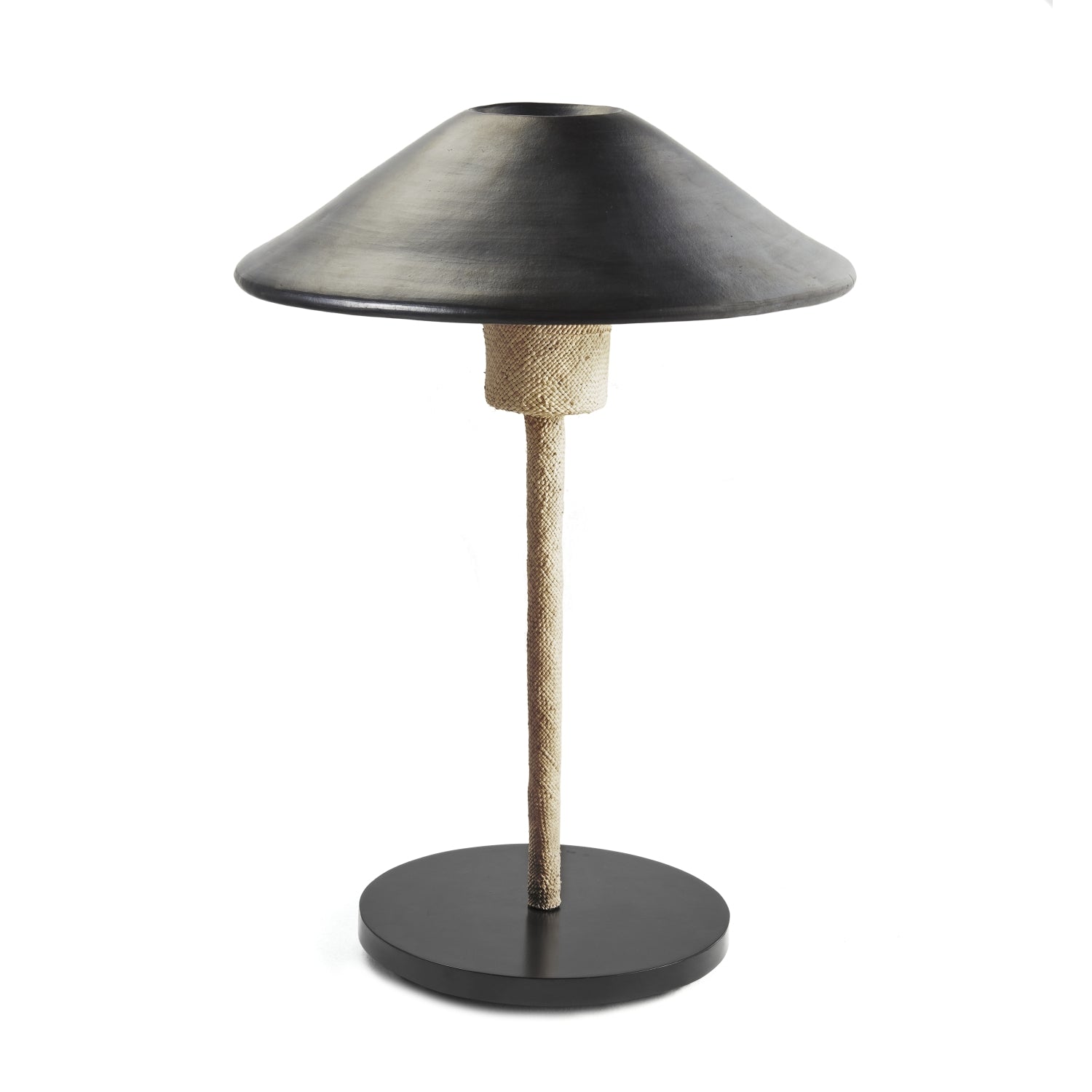 The Raiz Table Lamp by Ames features a modern design with a wide black conical shade, textured light-colored stem, and round black base. Its minimalistic style is enriched with Colombian craftsmanship for a sleek and contemporary look.