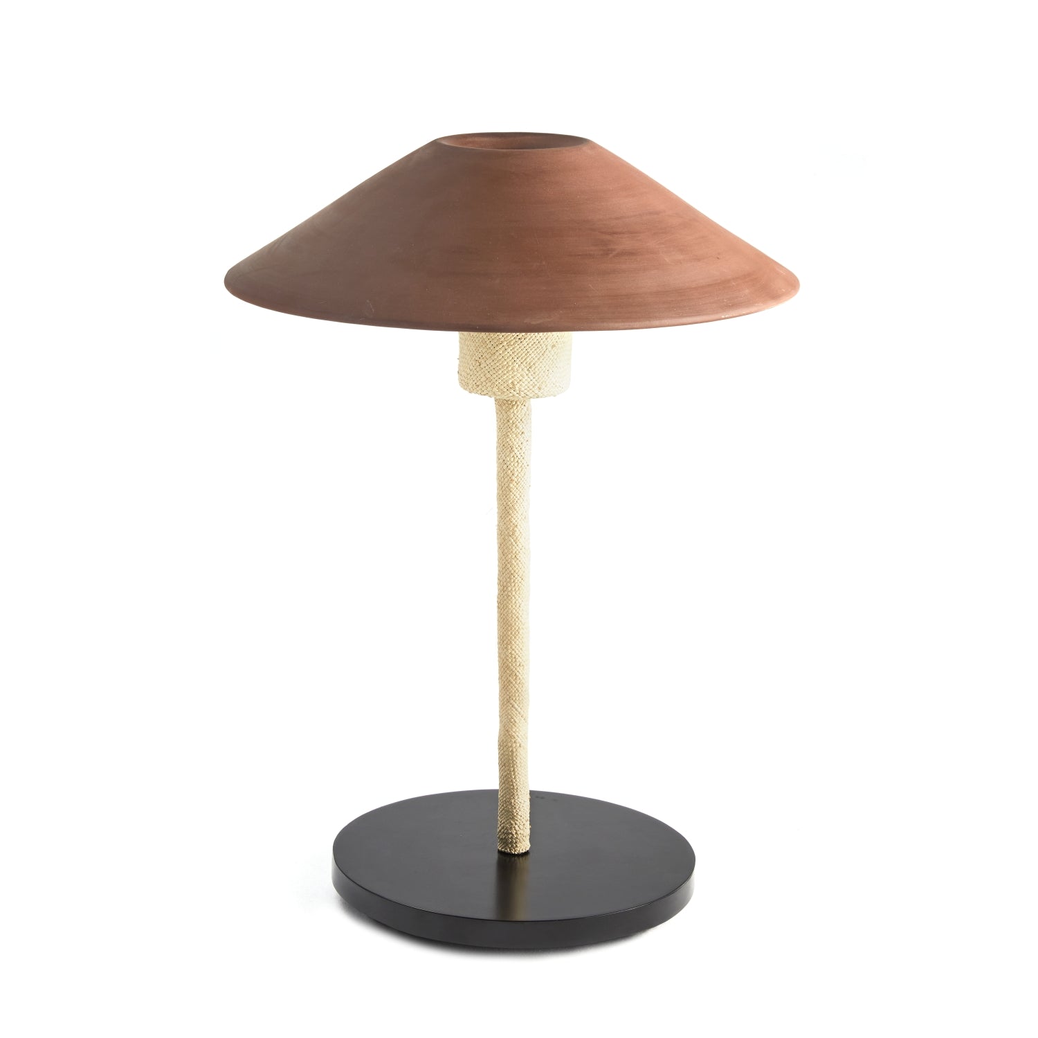 The Raiz Table Lamp by Ames showcases a conical brown shade inspired by Colombian craftsmanship, a textured beige stem, and a round black base, blending earthy and modern elements.