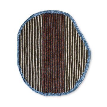 The Uilas Noche Rug by Ames is a round rug made of black dyed fique fiber, boasting a slightly uneven shape. Black, white, and red vertical stripes contrast with the blue edge for a luxurious effect.