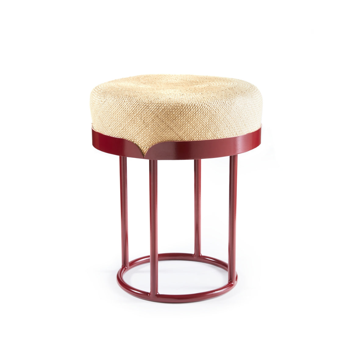 The Ames Victorias Pouf by Ames is a round stool inspired by Amazonia, featuring a woven natural-colored seat and a bold circular red metal frame with four legs joined at the base.