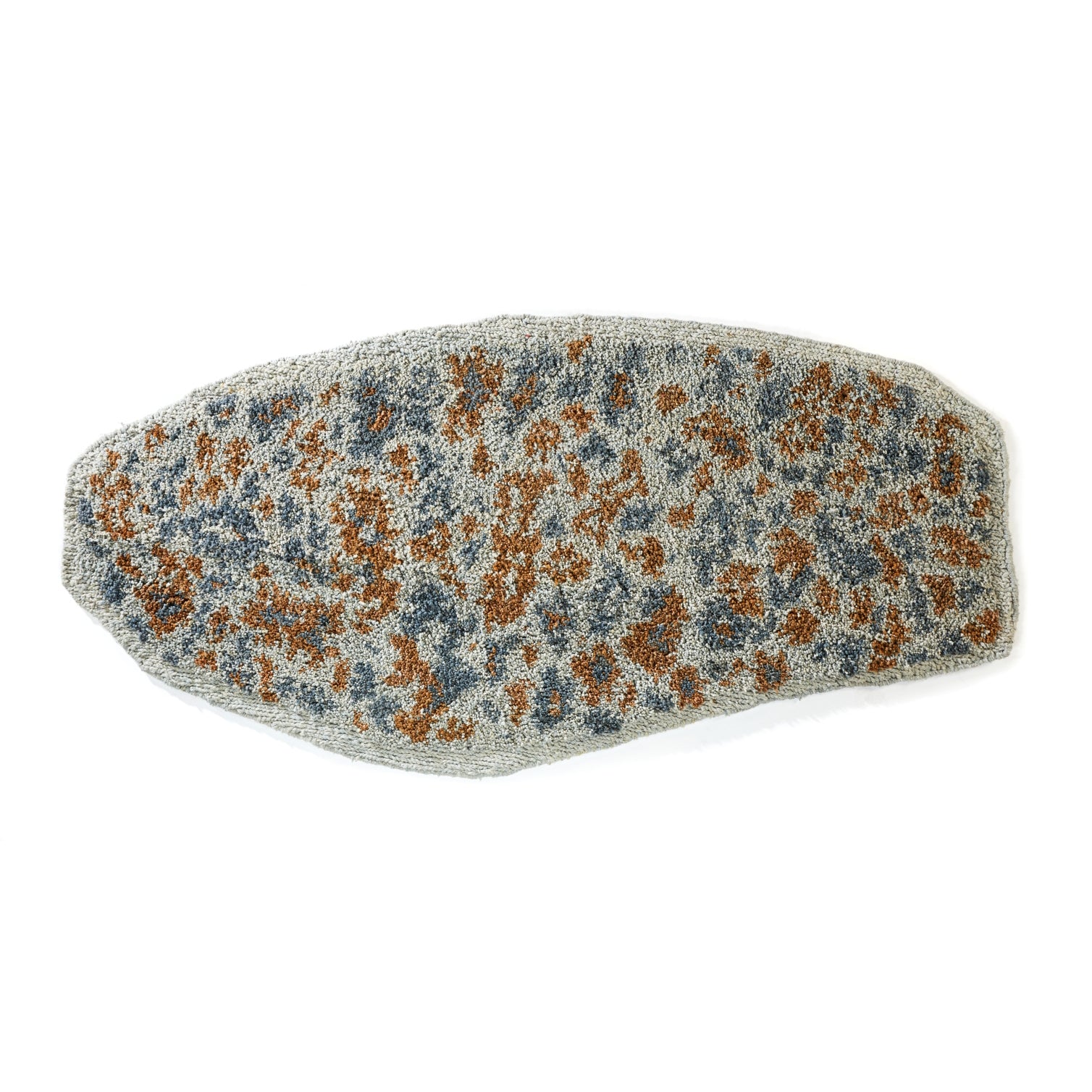 The Ames Zipa Rug by Ames is a flat, oval mat with a textured surface and gray-brown speckled patterns, reminiscent of Sebastian Herkner's Zipa rugs and evoking an animal print.