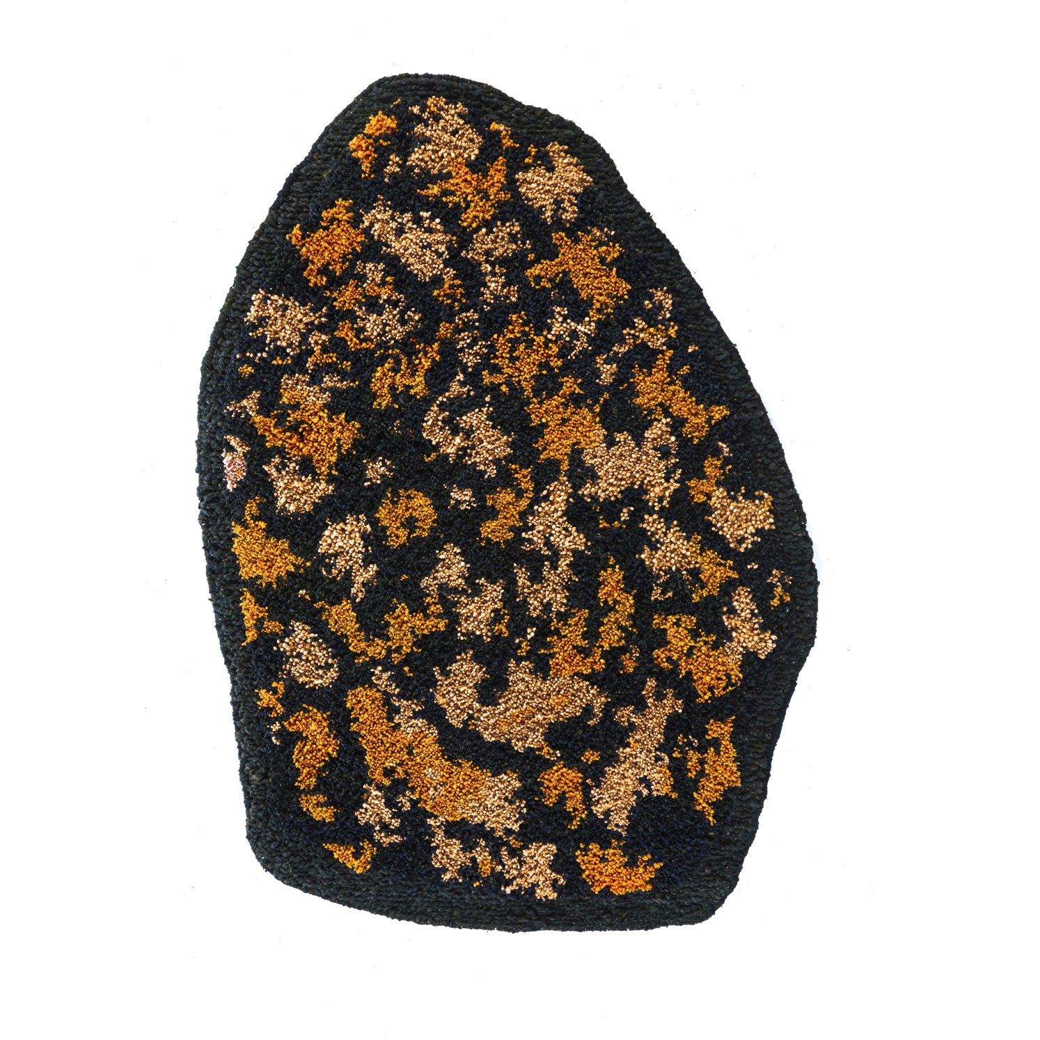 The Ames Zipa Rug by Ames features a textured black surface with gold and copper specks, inspired by Sebastian Herkner’s bold designs, shown here against a white background.