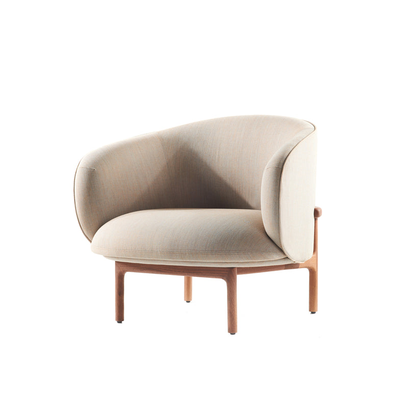 The MELA Lounge Chair Trimmed by Artisan features a beige, rounded backrest and cushioned seat on a sleek wooden frame. This modern armchair, inspired by mid-century design, combines an upholstered shell with contemporary comfort.