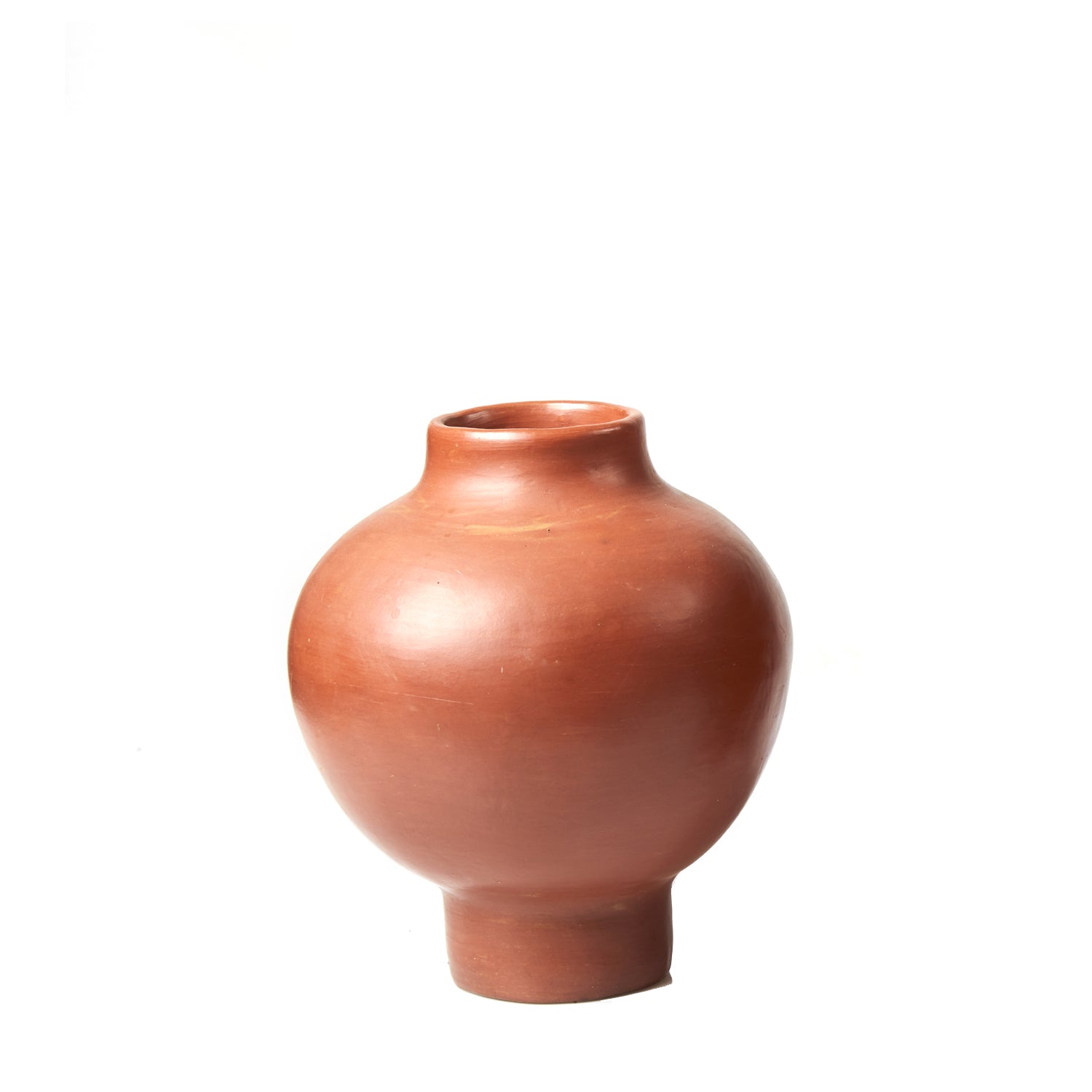 The Ames Barro Vase by Ames features a round, reddish-brown clay form with a narrow neck and flared base, reflecting the beauty of handmade Colombian ceramics and shown against a plain white background.
