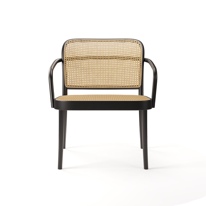 The TON Lounge Armchair 811 showcases a black metal frame with cane weaves on the rattan backrest and seat. It features sleek, curved armrests, set against a plain white background.