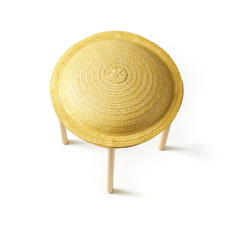 A round, woven yellow Cana Stool by Ames features a textured top and light wooden legs. Viewed from above against a white background, this unique stool adds vibrant color to any space.
