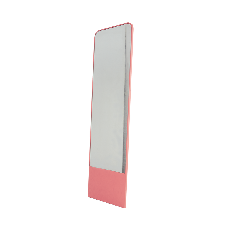 The Friedrich Mirror by Objekte unserer Tage is a tall, rectangular piece with a pink frame, slightly angled against a white background. It embodies minimalist design, perfect for adding elegance to a contemporary living space.