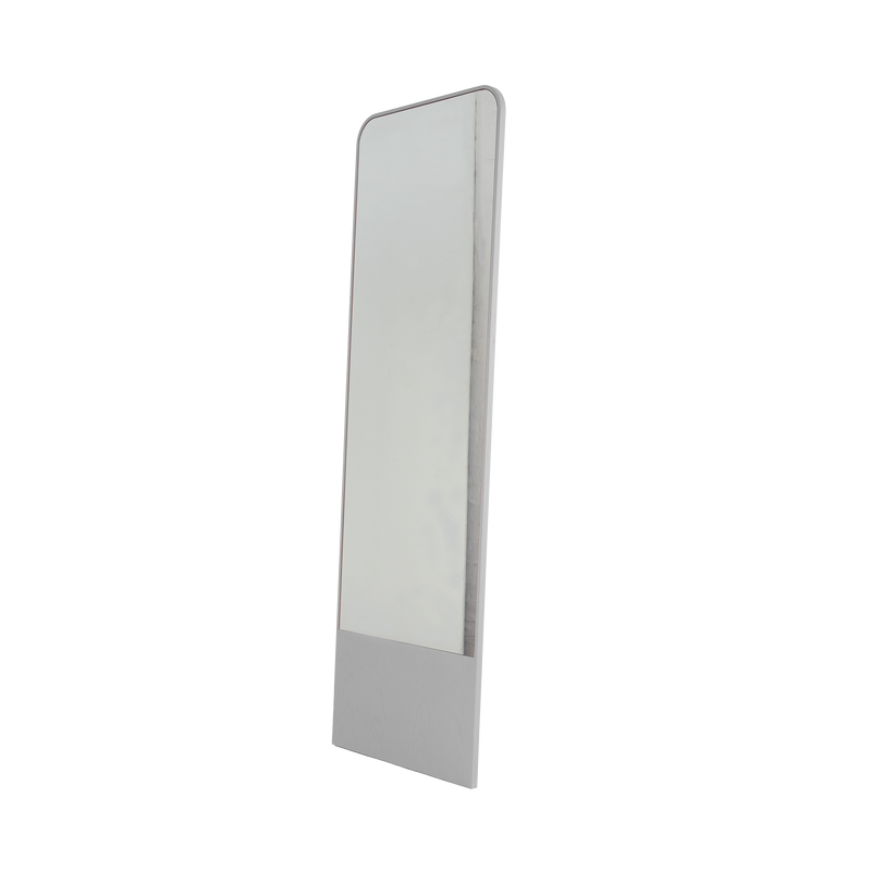 The Friedrich Mirror by Objekte unserer Tage is tall and rectangular, with a slim, sleek frame ideal for contemporary spaces. Its minimalist design features a slight backward tilt supported by a sturdy stand, giving it a modern look.