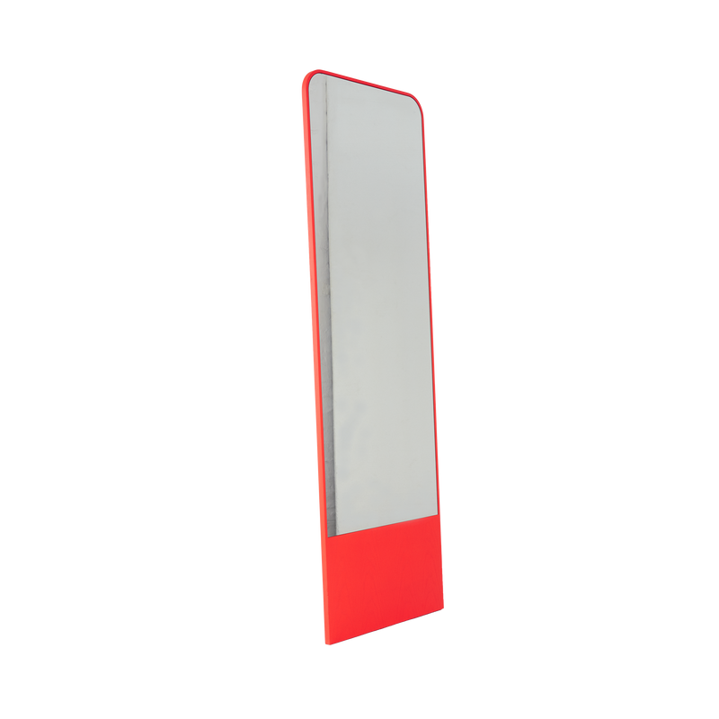 The Friedrich Mirror by Objekte unserer Tage is a rectangular full-length mirror with a red border and base, angled to the side on a white background. It offers minimalist design, seamlessly combining functionality and aesthetic appeal, ideal for a contemporary living space.