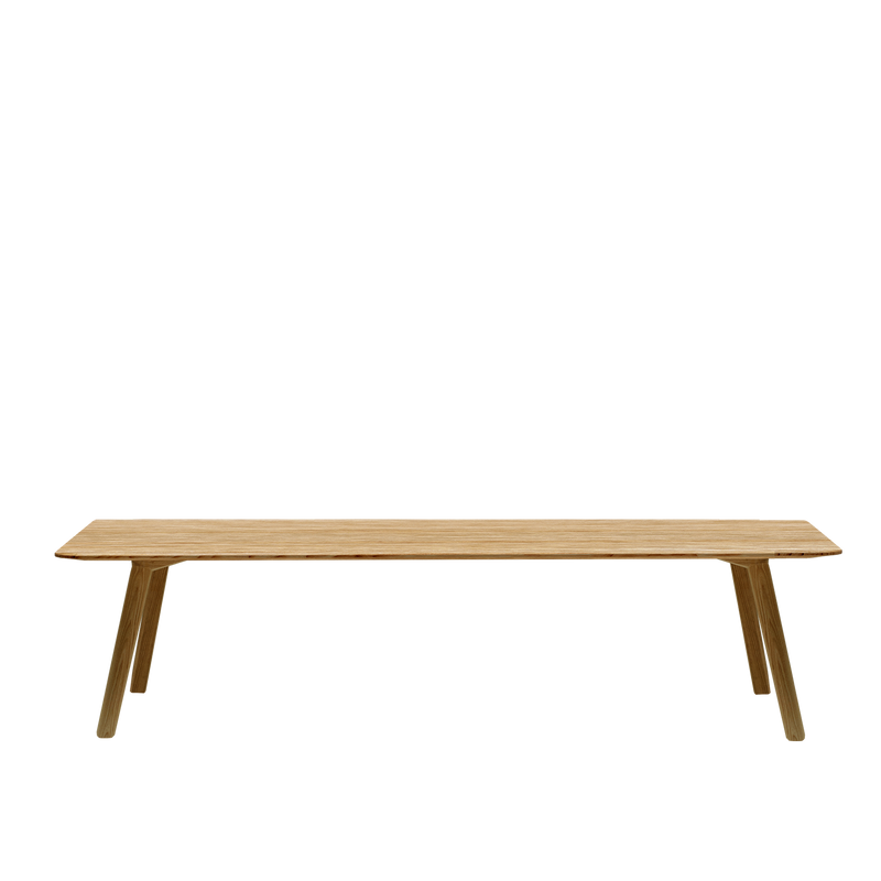 The Meyer Bench by Objekte unserer Tage features a minimalist design with a flat seat and angled legs, crafted from solid ash. Its simple, light-colored wooden structure stands out elegantly against a plain white background.