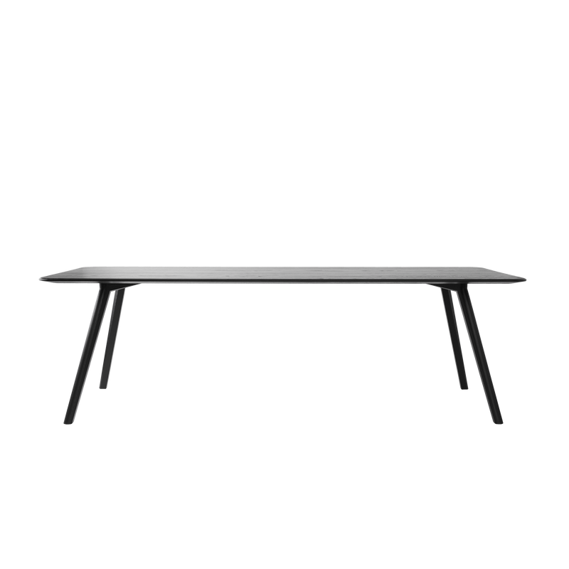 The Meyer Table by Objekte unserer Tage is a minimalist black rectangular piece made from solid ash, featuring a slim flat top and four angled legs, elegantly set against a plain black background.