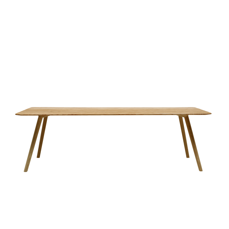 The MEYER Table by Objekte unserer Tage is a minimalist piece made from solid oak with a light natural finish, boasting a rectangular top. Its sleek modern look is enhanced by four slanted legs, all set against a plain white background.