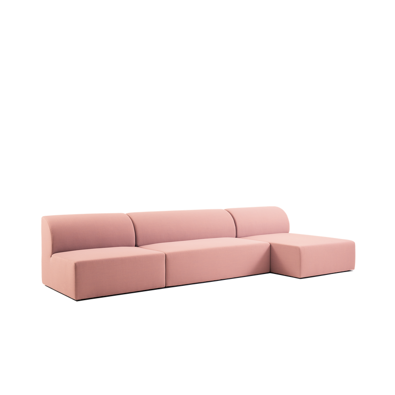 A modern, minimalist L-shaped Weber Modular Sofa from Objekte unserer Tage in pink with clean lines and concealed legs against a white background. Featuring a low backrest and four sections, it captures German sensuality while blending style with sustainability.