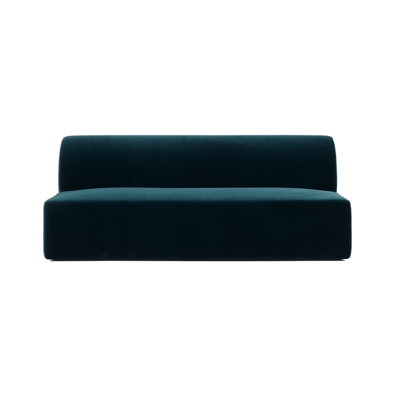 The Weber Modular Sofa by Objekte unserer Tage is a modern dark teal velvet piece exuding German sensuality. Its minimalist design features a simple boxy shape with a straight backrest and seat, no armrests, and it rests on a flat surface without visible legs or embellishments.