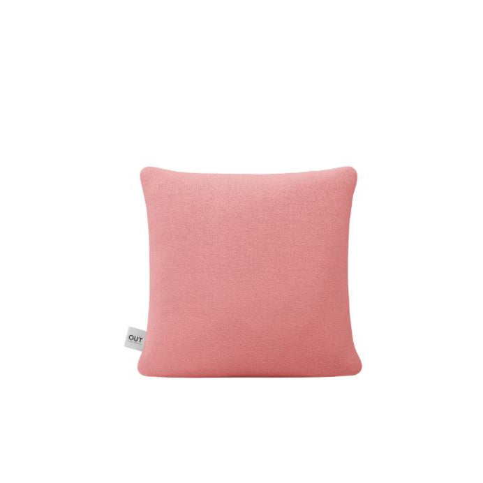 The Weber Cushion by Objekte unserer Tage is a square, pale pink pillow made from upholstery fabric, featuring a small white tag on its side. It is perfectly centered against a plain white background.