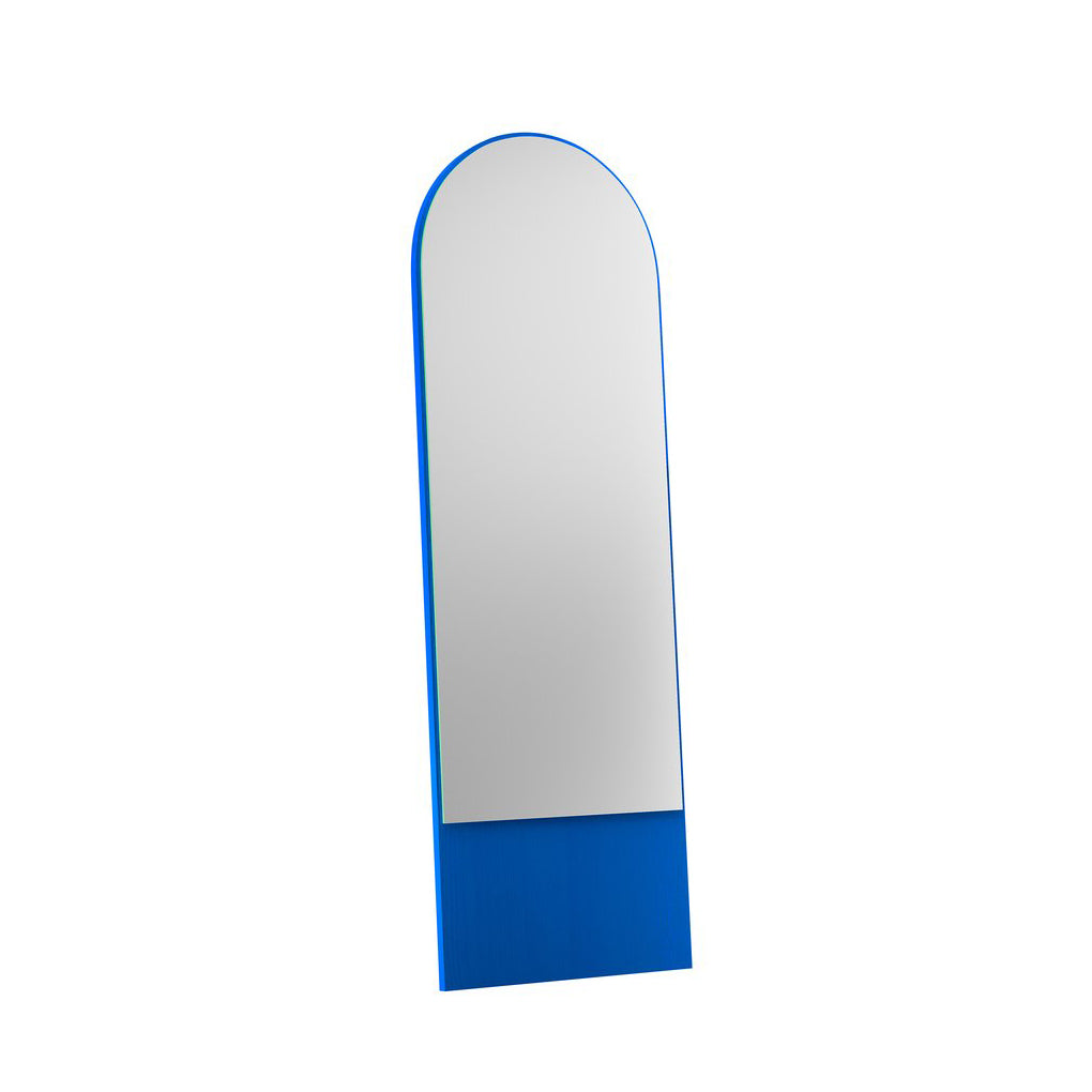 Discover the beautiful FRIEDRICH 21 Mirror by Objekte unserer Tage, featuring a vibrant blue lacquered ash wood frame and a graceful, round arch design. This tall, freestanding mirror leans elegantly against any plain white backdrop.