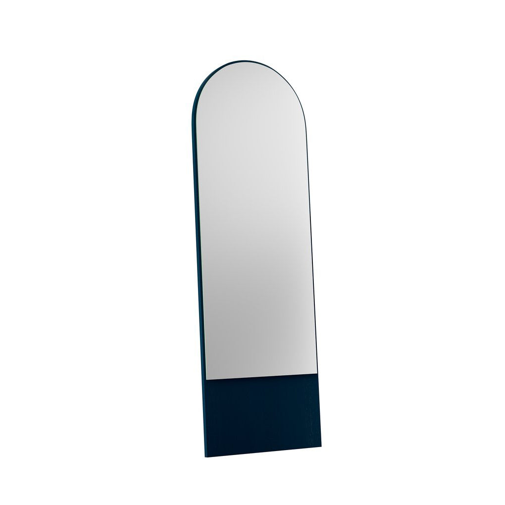 The FRIEDRICH 21 Mirror by Objekte unserer Tage is a freestanding, arched full-length mirror with a dark, rectangular base made of lacquered ash wood. Its minimalist and modern design elegantly stands at an angle.