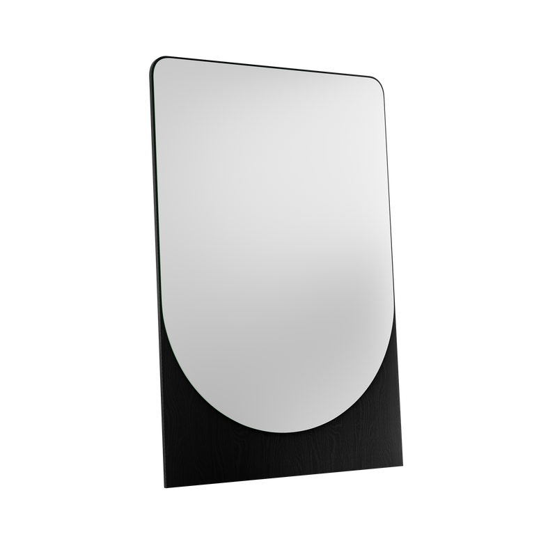 The FRIEDRICH MAX Mirror, designed by Objekte unserer Tage, is a contemporary, large mirror with rounded top edges, mounted on a black wooden stand against a solid black background.