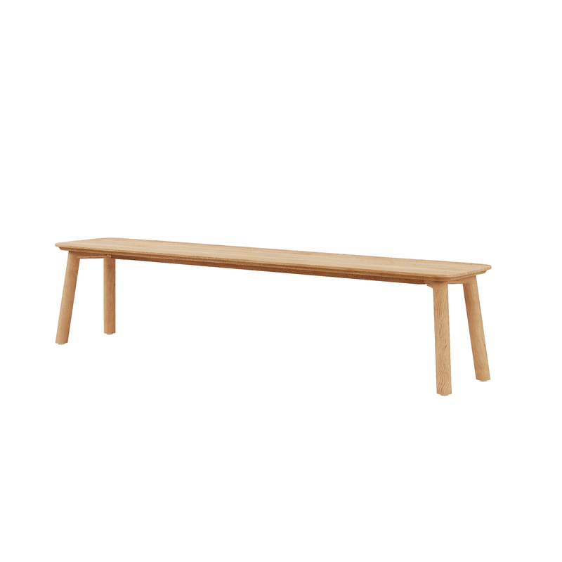 The Meyer 23 Bench by Objekte unserer Tage features a minimalist design with solid wood construction, a long rectangular seat, and four simple rounded legs, showcasing its natural look with a light wood finish and reflecting sustainable forestry practices.
