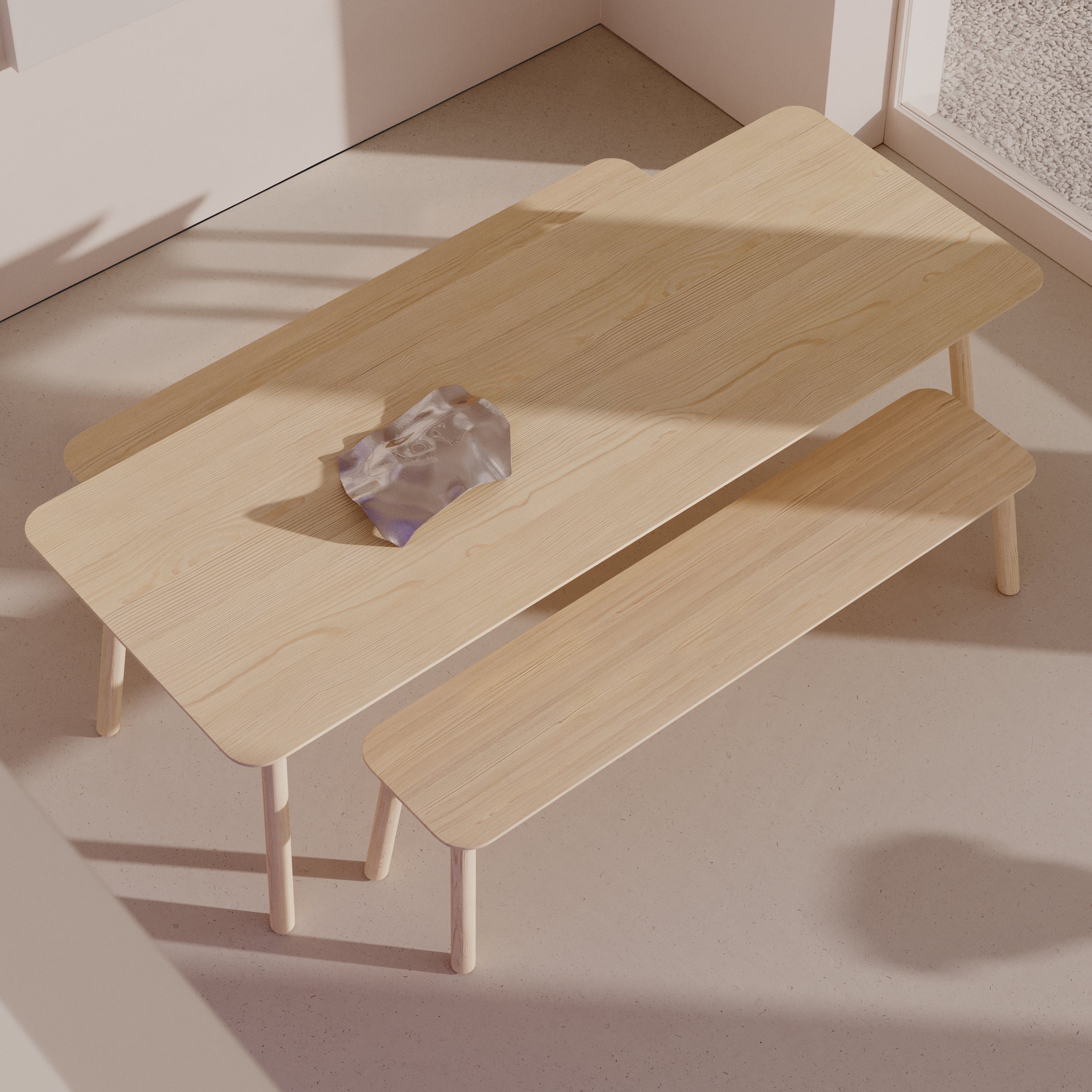 A solid wood dining table with an Objekte unserer Tage Meyer 23 Bench, crafted from sustainably sourced materials, sits on a light floor. Sunlight streams through the window, casting shadows on a decorative purple object adorning the tabletop.