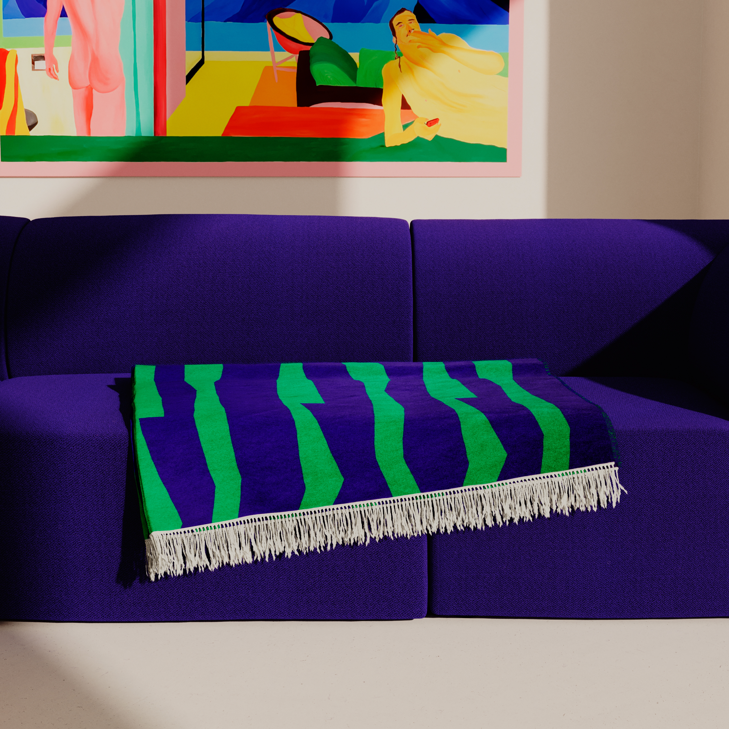 A vibrant room showcases a deep purple couch adorned with an organic cotton SEIDEL Throw by Objekte unserer Tage. An abstract graphic art piece with bold hues decorates the wall above, while soft sunlight filters through to illuminate the scene.