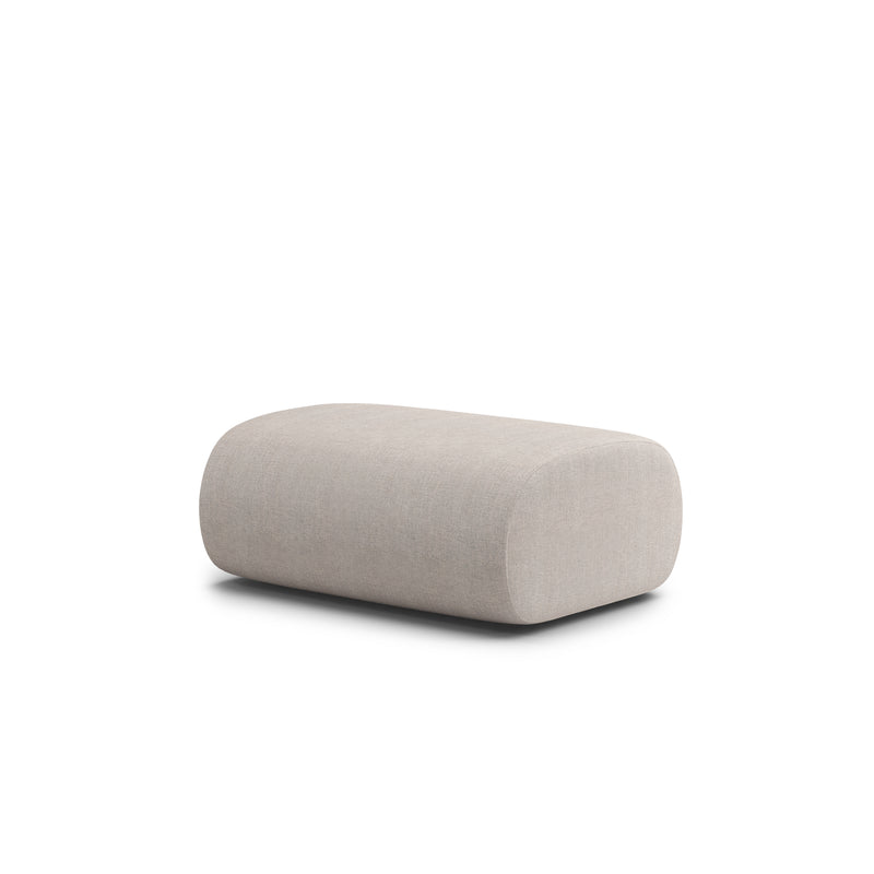 The Ola Pouf by Objekte unserer Tage is a beige, rectangular ottoman with rounded edges. Upholstered in a textured fabric similar to the OLA Sofa, it complements any modular setup with style and adaptability against a plain white background.