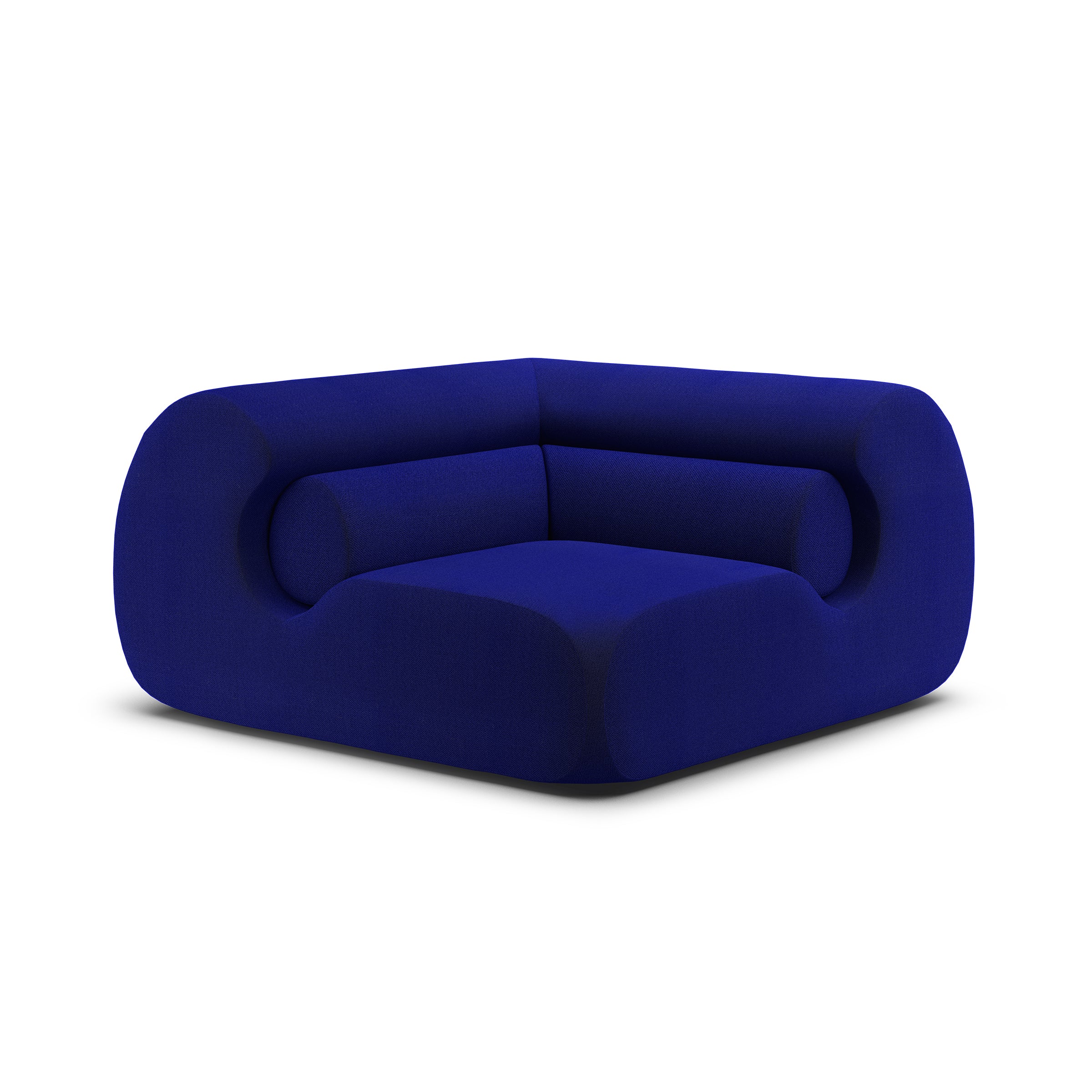 The Ola Sofa by Objekte unserer Tage is a modern deep blue velvet armchair reminiscent of the Mediterranean Sea, boasting a bold, rounded design with thick memory foam cushions and seamless upholstery for a stylish, cozy look on a white background.
