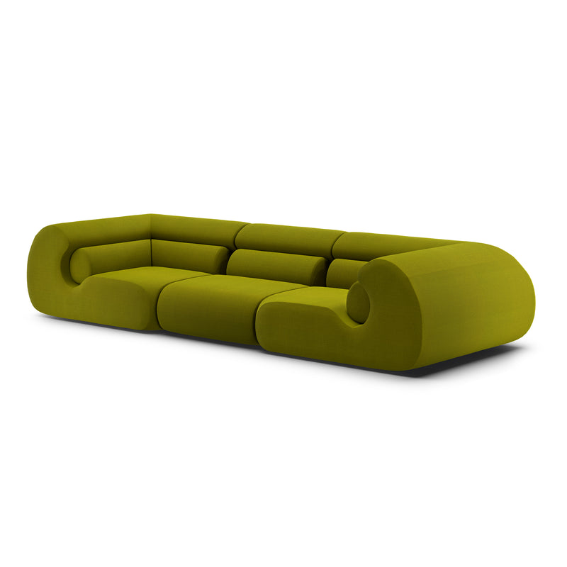 The Ola Sofa by Objekte unserer Tage is a modern green sectional with rounded edges and a minimalist design, featuring luxurious memory foam cushioning, shown against a plain white background.