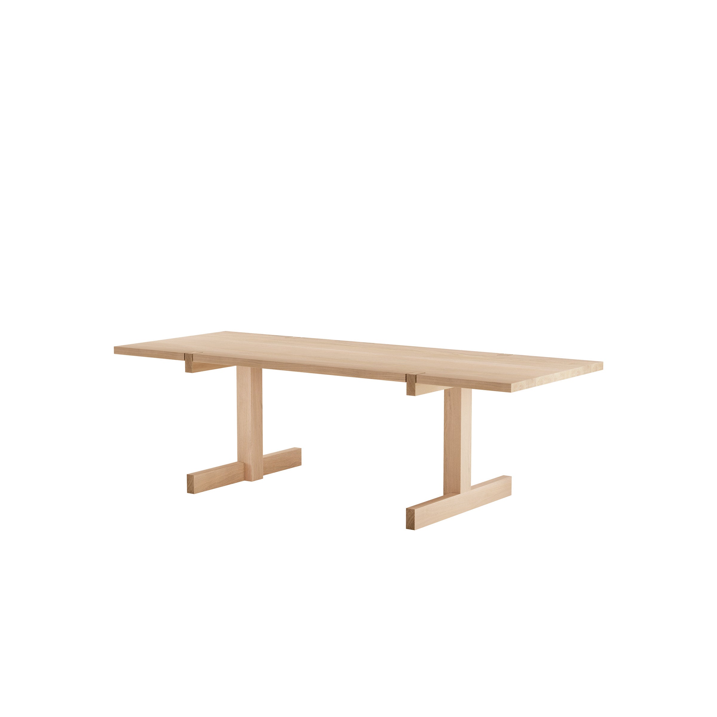 The Objekte unserer Tage Richter Table is a minimalist wooden piece with a light natural finish, featuring a flat rectangular top and simple T-shaped legs. Handcrafted from sustainable forestry, it has a clean, contemporary design without decorations.