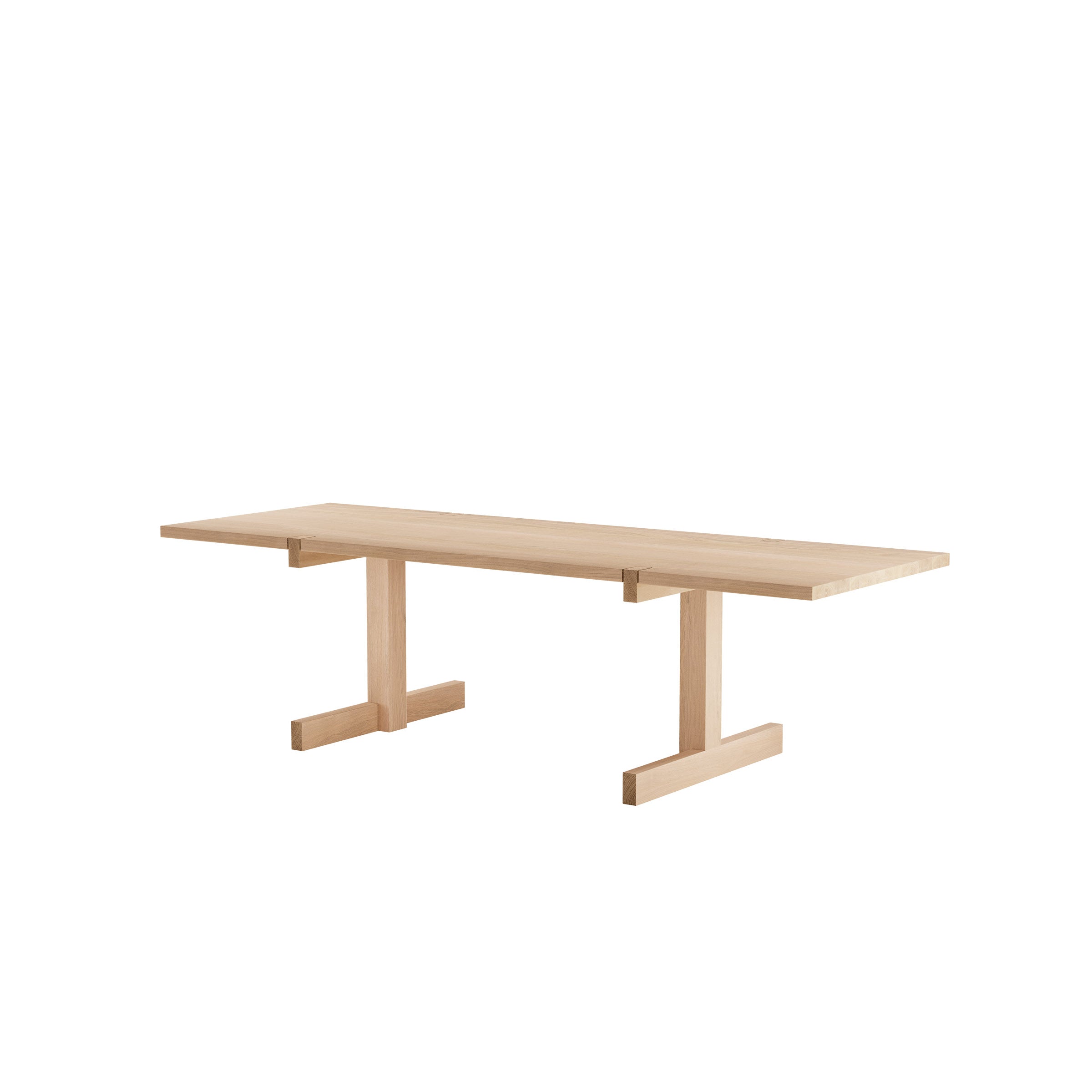 The Richter Table by Objekte unserer Tage is a minimalist piece with a flat rectangular top and T-shaped bases, crafted from sustainably sourced light wood. Its simple, modern design features clean lines and functionality.