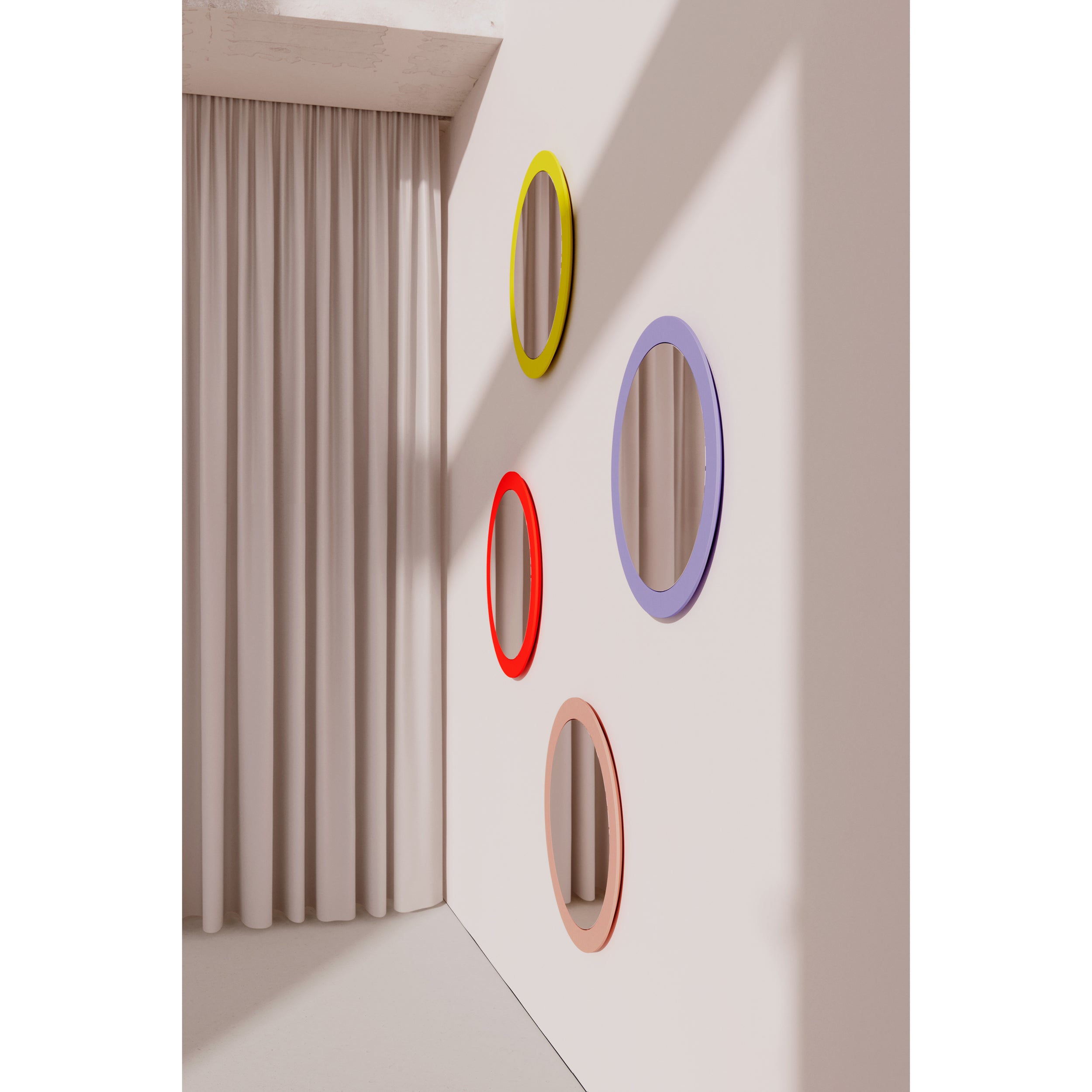 The Lorenz Mirror collection by Objekte unserer Tage features four circular mirrors with vibrant frames in yellow, red, lavender, and peach on a white wall. Beige curtains to the left enhance the modern artistic design with shadows, embodying a contemporary aesthetic.