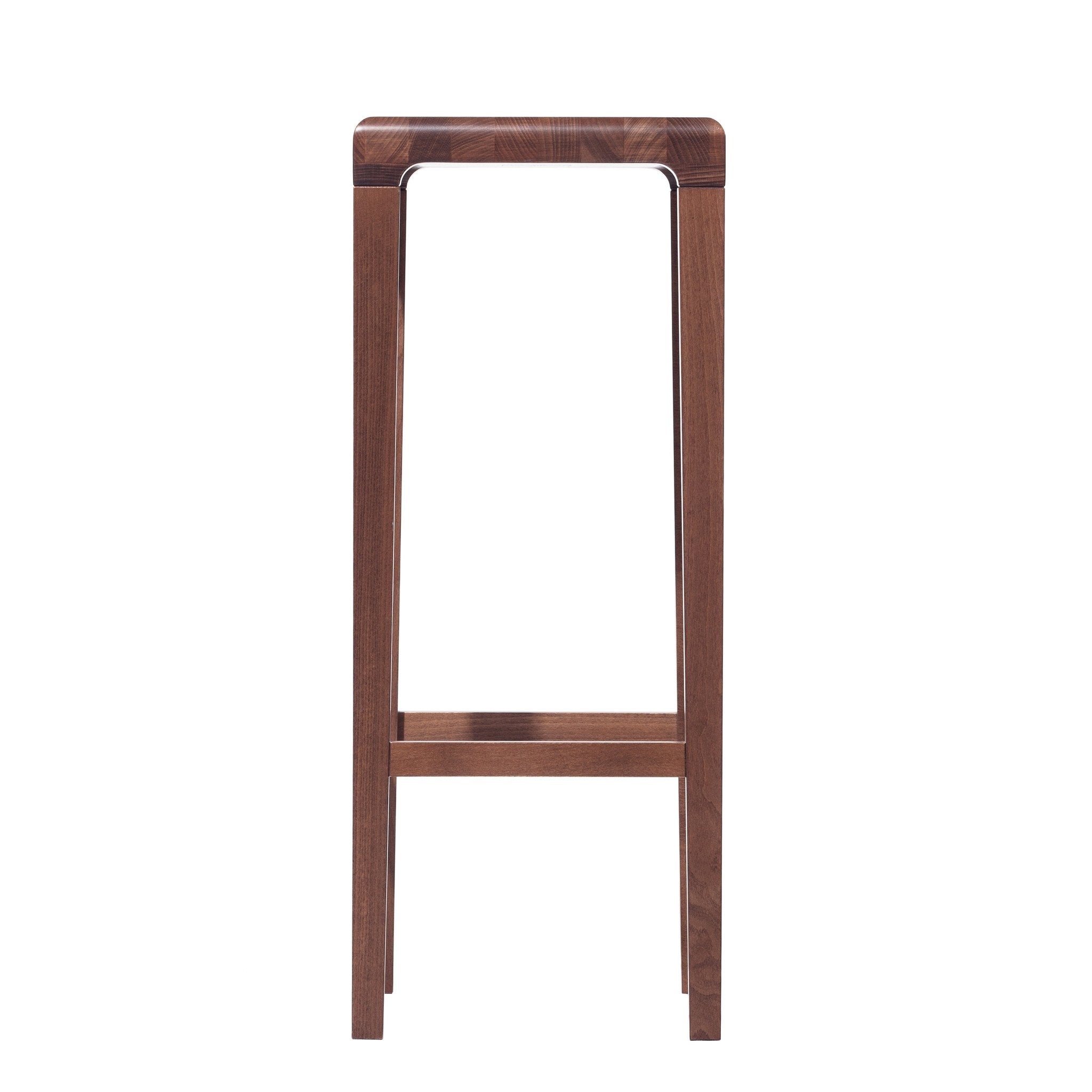 The Barstool Rioja by TON is a tall, backless design made from oak, featuring four straight legs linked by support beams. It has a minimalistic style with a smooth, rectangular seat and natural wood finish.