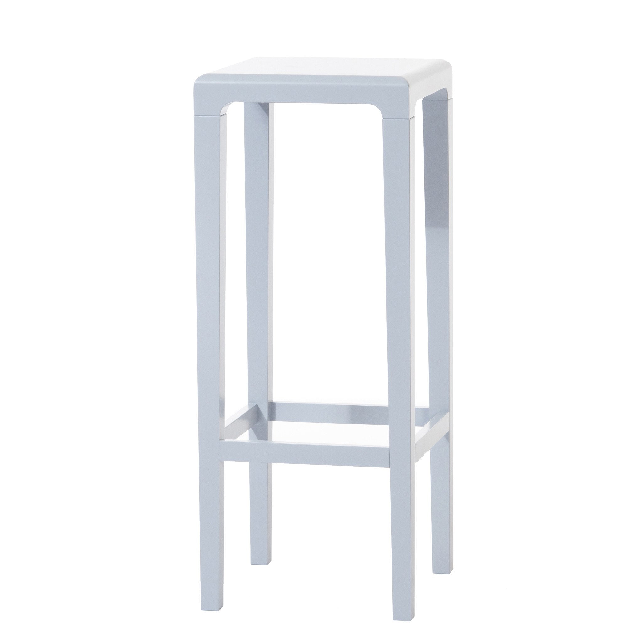 The Barstool Rioja by TON is a sleek, modern piece with a minimalist design. It features a square white seat, tall oak legs, and clean lines. A crossbar near the base provides support.