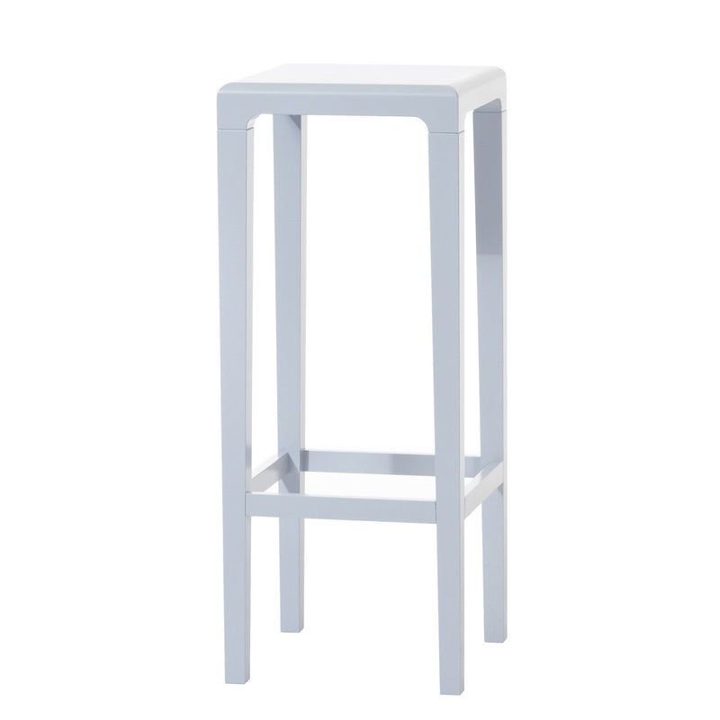 The Barstool Rioja by TON is a sleek, modern piece with a minimalist design. It features a square white seat, tall oak legs, and clean lines. A crossbar near the base provides support.