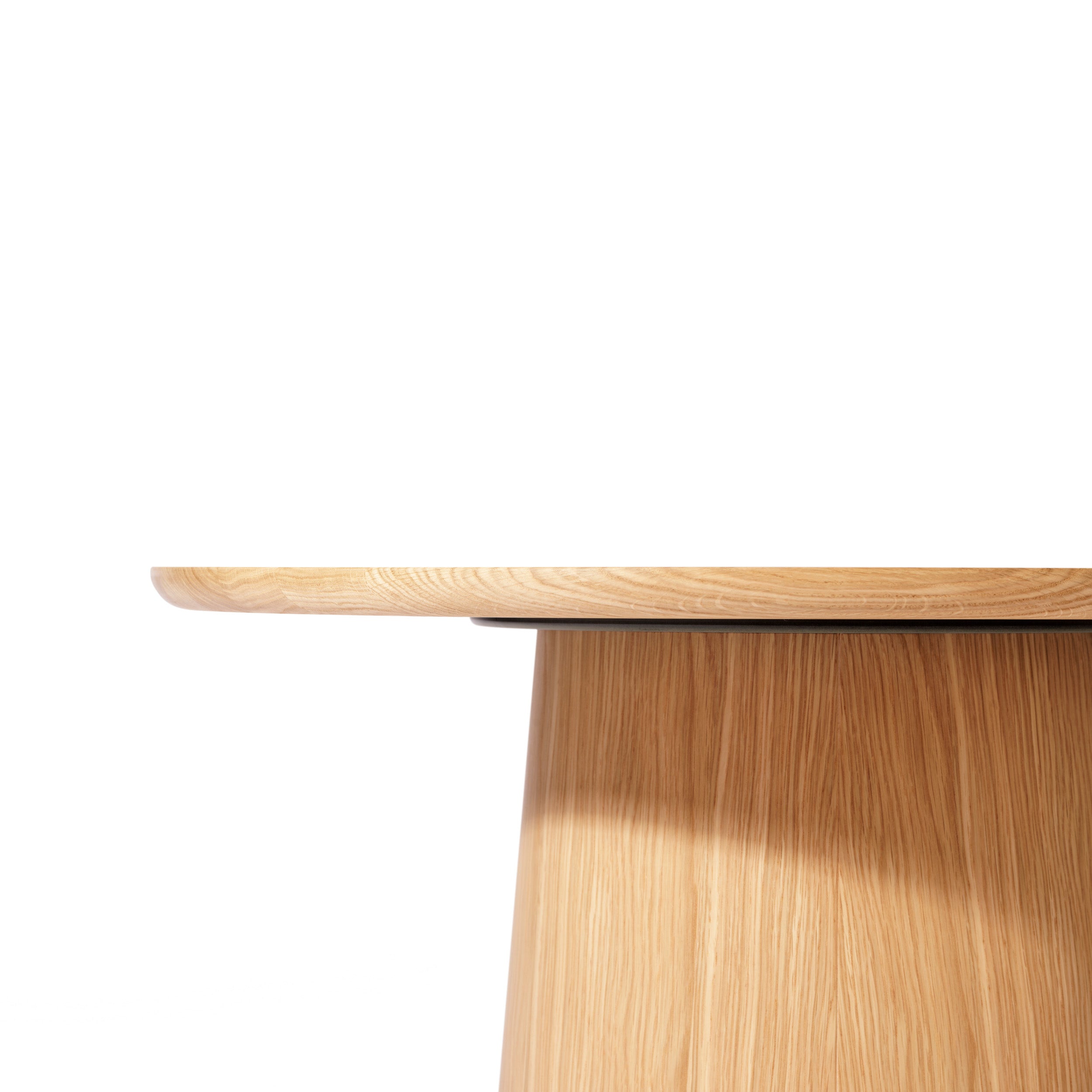 The P.O.V. Coffee Table 474/475 by TON features a round solid wood design with a smooth surface and a wide cylindrical base. Its visible wood grain highlights various color finishes, offering a modern and minimalist aesthetic against a white backdrop.