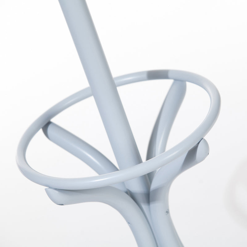 Close-up of the Stand by 020 stool leg in light blue metal with a manually bent circular footrest, emphasizing universal use and craftsmanship, against a white background. Presented by TON.