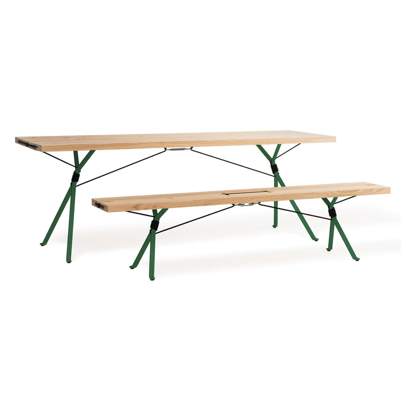 The Moormann Kampenwand Table and bench set features a minimalist design with a wooden surface and green metal legs. The elevated table is complemented by a lower bench, both showcasing clean lines and modern aesthetics.